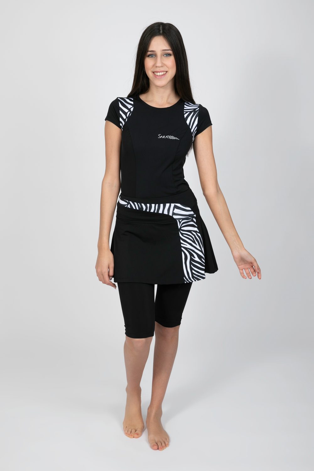 Model wearing the Tennis Design Set with fitted cap-sleeve top and short flared skort